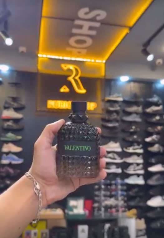 Flacon de parfum devant le logo doré Rubio Shop